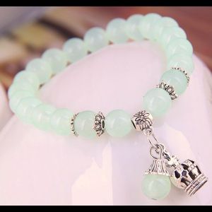Light green metal crown and ball bracelet